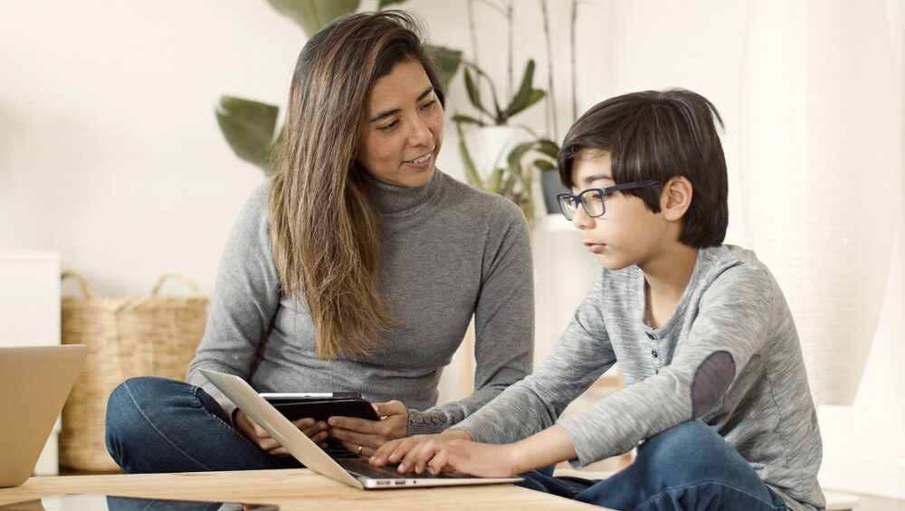 Kerala parent and child reviewing CBSE online tuition options together on a laptop