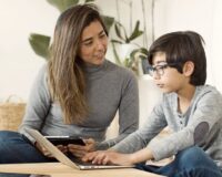 Kerala parent and child reviewing CBSE online tuition options together on a laptop