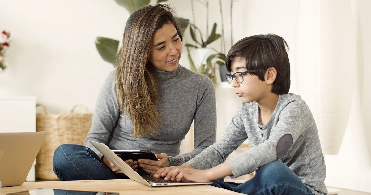 Kerala parent and child reviewing CBSE online tuition options together on a laptop
