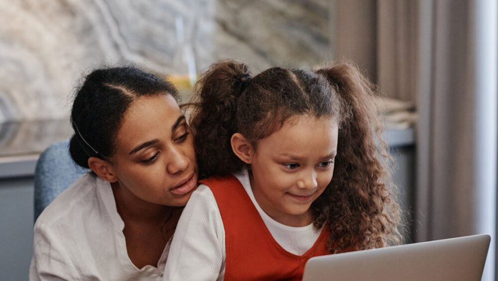 Kerala parent and CBSE student reviewing online tuition together on a laptop at home