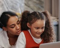Kerala parent and CBSE student reviewing online tuition together on a laptop at home