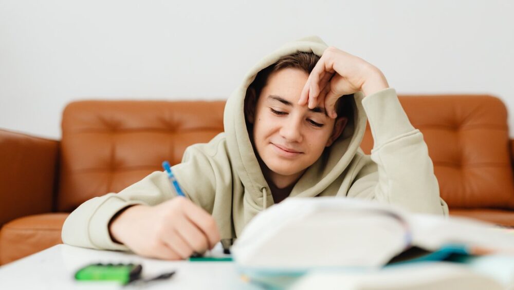 CBSE Class 10 student studying biology notes at home for online tuition