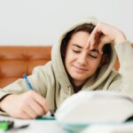 CBSE Class 10 student studying biology notes at home for online tuition