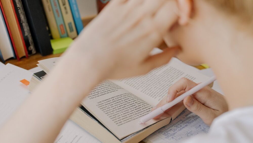 CBSE student writing in a notebook as part of online English tuition