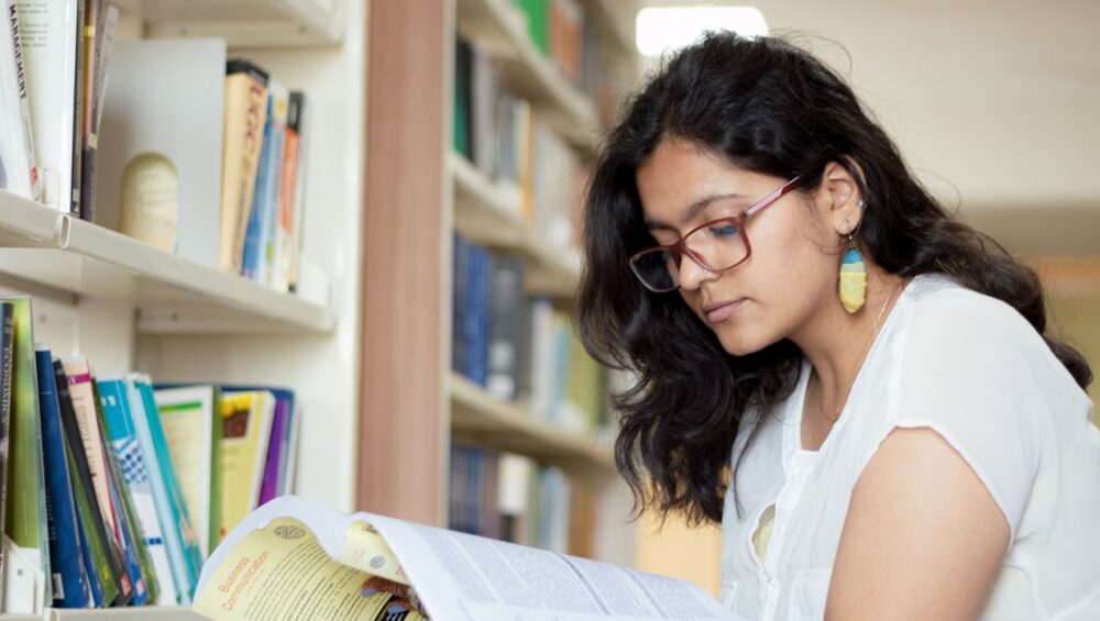 CBSE student reading a Hindi textbook as part of online Hindi tuition