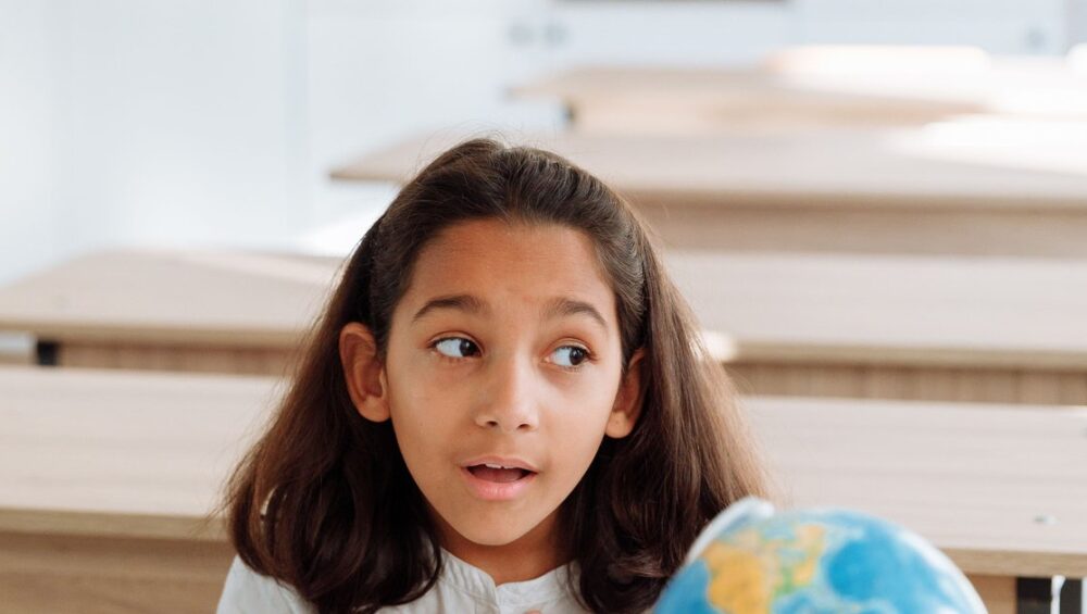CBSE student studying geography with a globe as part of online social science tuition
