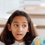 CBSE student studying geography with a globe as part of online social science tuition