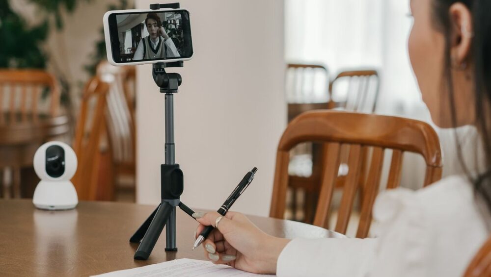 Student comparing online tuition apps on a smartphone at home