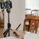 Student comparing online tuition apps on a smartphone at home